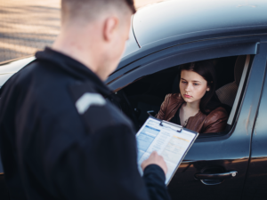 a girl being pulled over and given a ticket