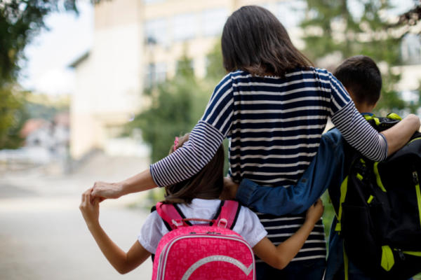 Mother walking students to a local public school.