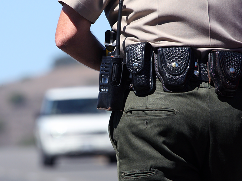 Police officer approaching vehicle