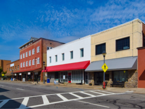 An empty street and closed businesses illustrate how rising crime can push communities into even greater poverty and lack of opportunity.