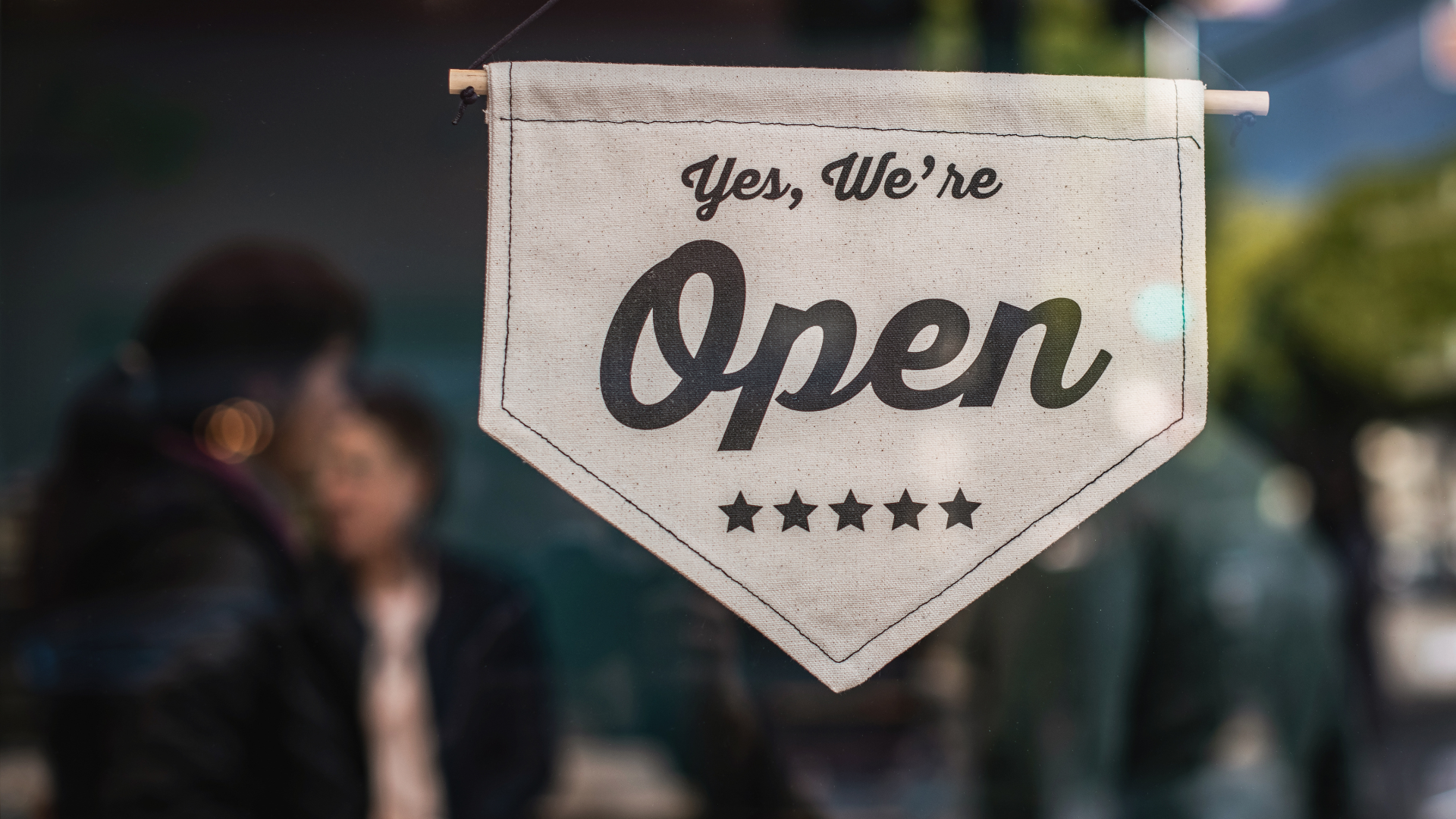 Local business displays %22open%22 sign. 