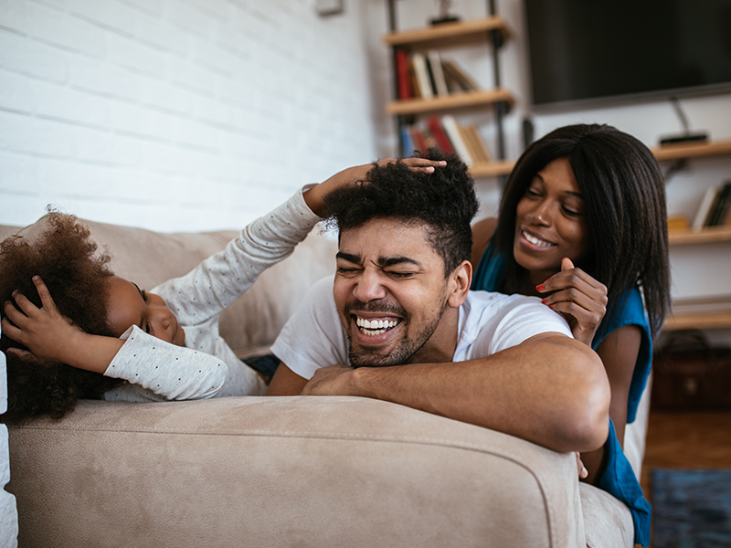 a family playing on the couch