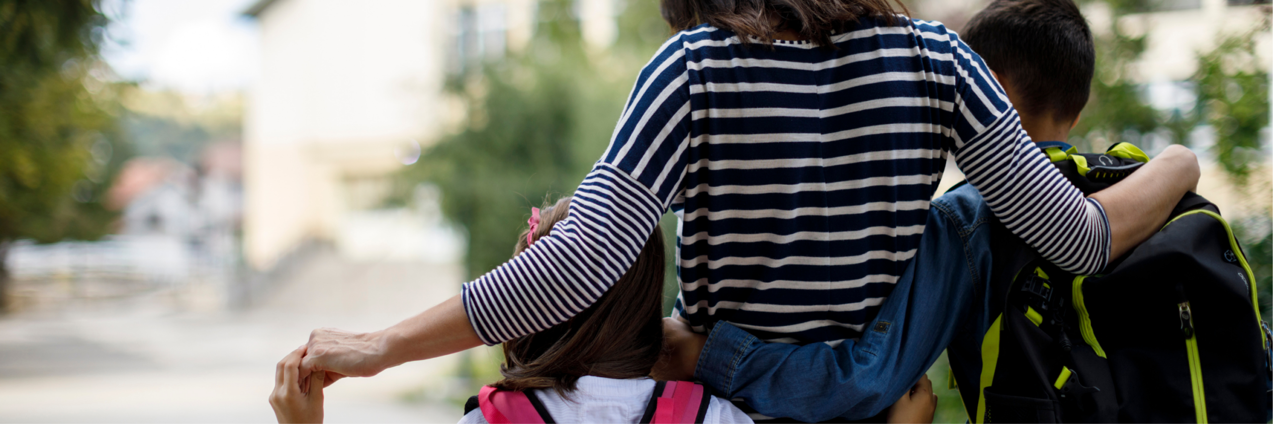 Mother walking students to a local public school.
