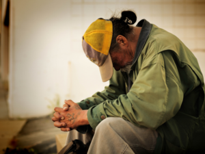 Man sitting with his hands folded