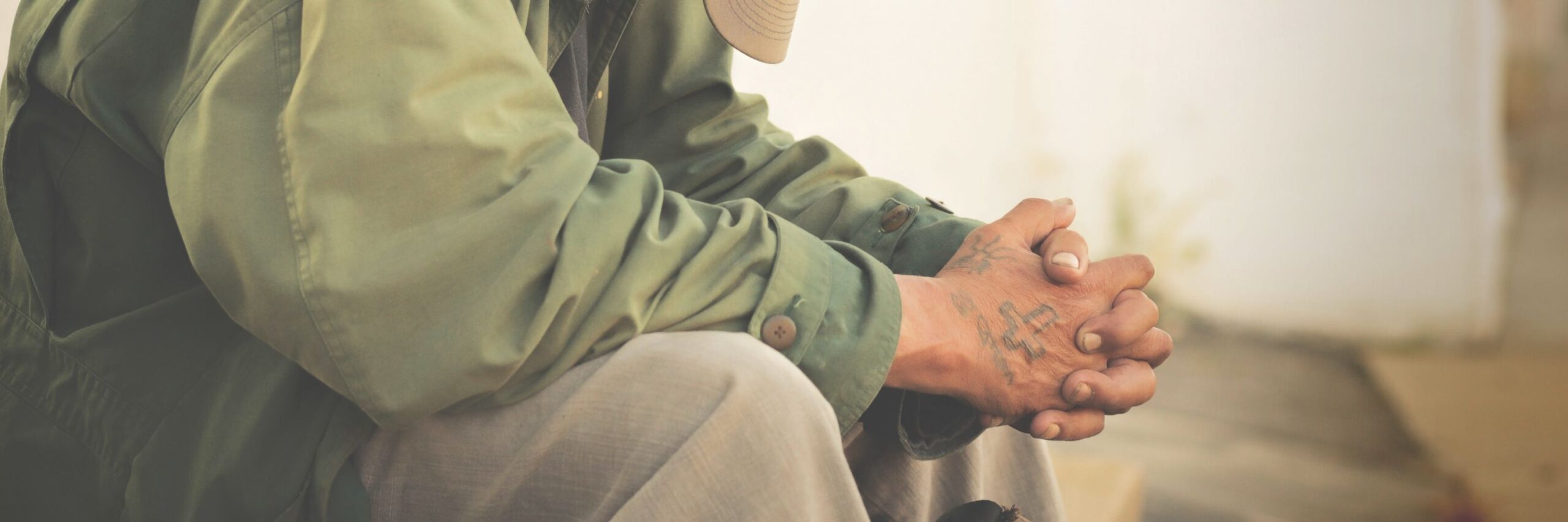 Man sitting with his hands folded