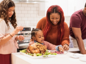 Family in kitchen Thanksgiving Dinner Turkey