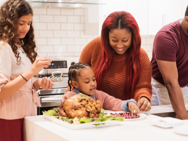Family in kitchen Thanksgiving Dinner Turkey