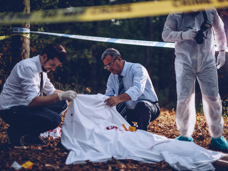 Photo of coroner looking at murder victim
