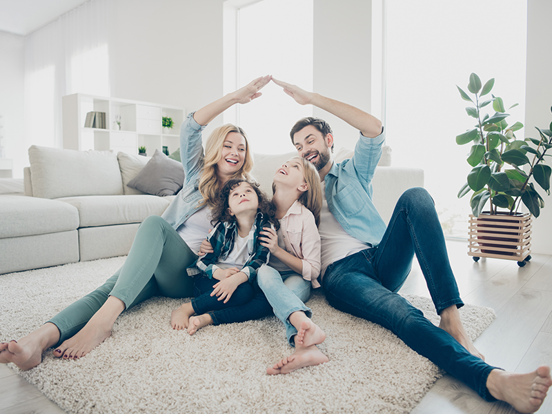A family sitting on the floor together