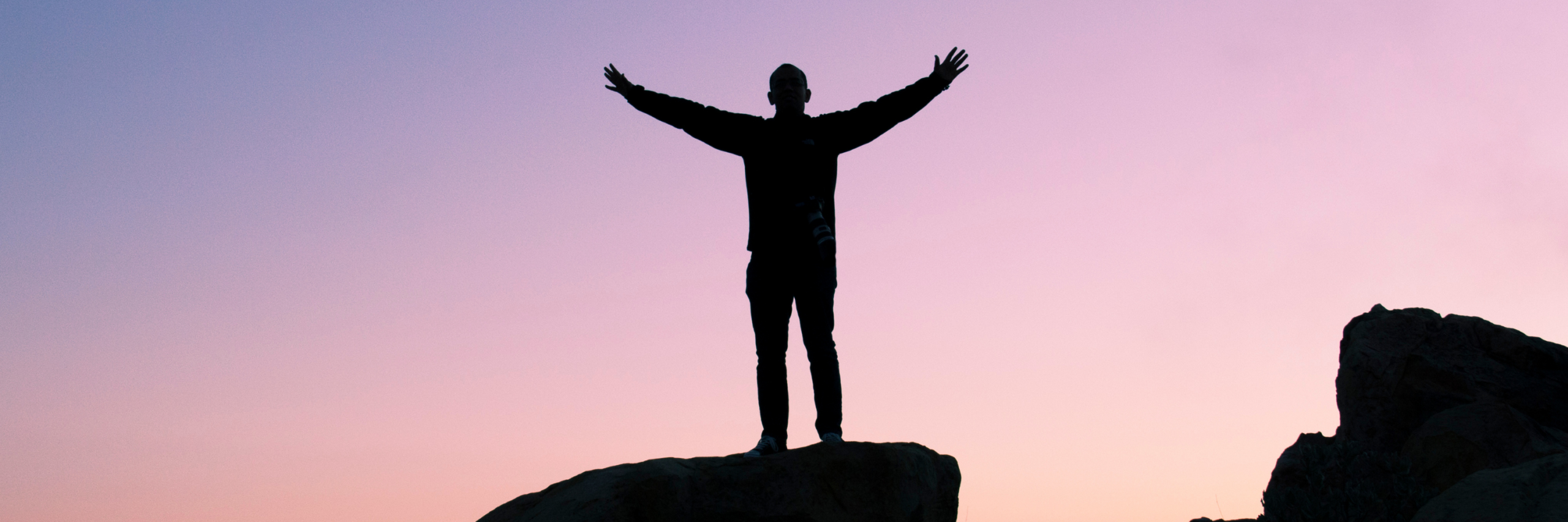 man on top of mountain