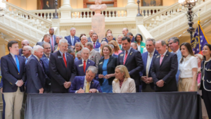 Georgia Governor Brian Kemp signs bills into law.
