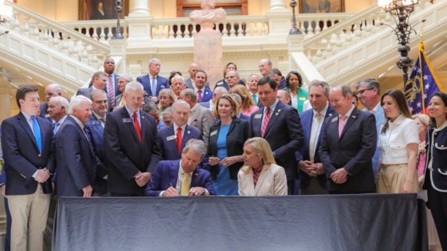 Georgia Governor Brian Kemp signs bills into law.